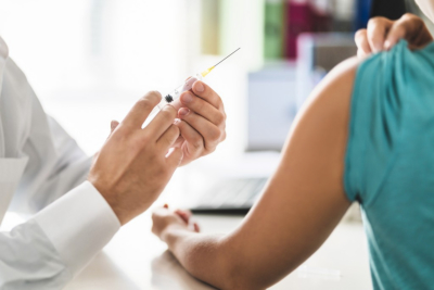 Physician or nurse giving vaccine